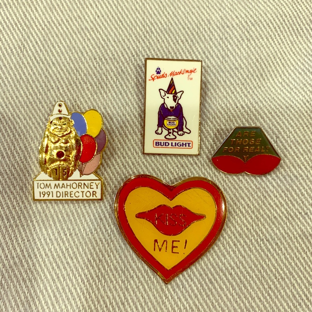 Four vintage pins including Bud's Spuds Mackenzie